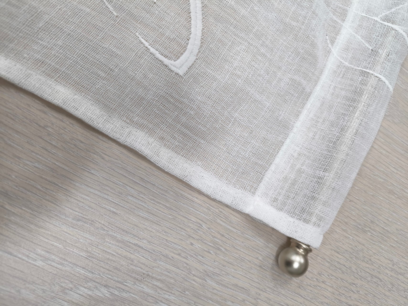 Dettaglio della parte superiore della tenda effetto lino con tasca e bastoncino inserito, sistema di montaggio per tende a vetro